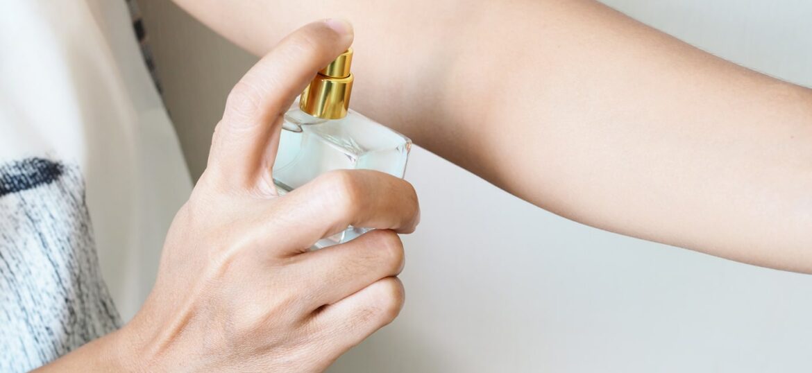 close-up-woman-spraying-perfume-arms-add-fragrance-body